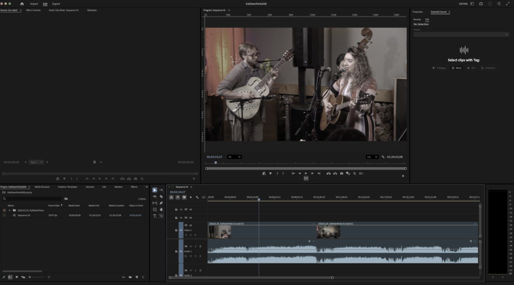 A video editing software interface displaying a performance. A man and a woman play guitars and sing into microphones, conveying a soulful mood.