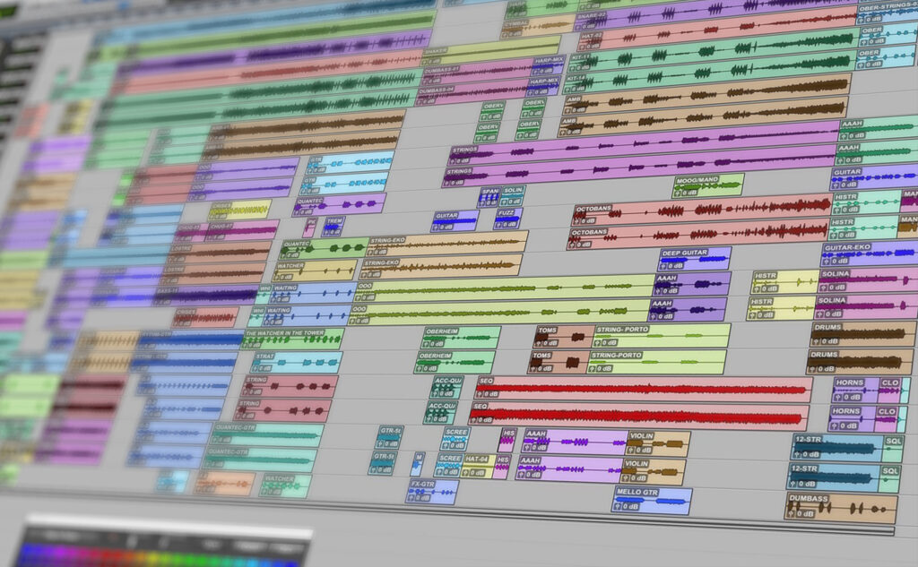 Pro Tools DAW audio editing software screen showing a complex, colorful, layered arrangement of soundtracks. The vibrant layout suggests intricate production work.