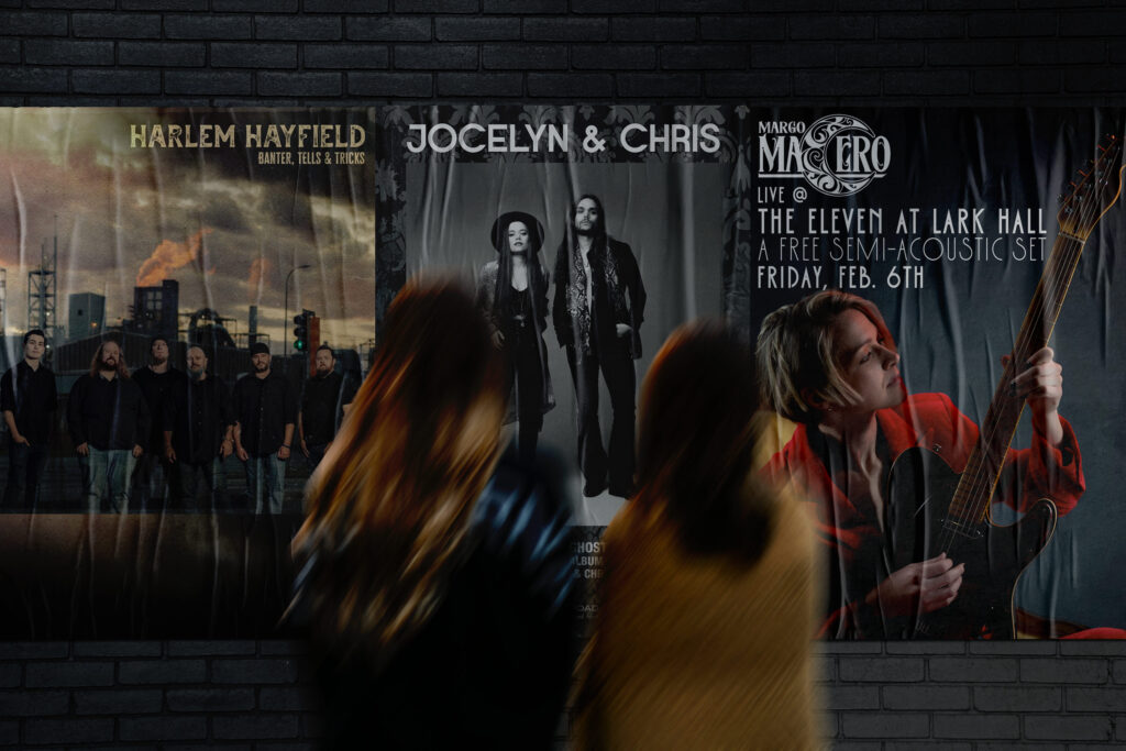 Blurred figures walk past a brick wall with music posters. Posters feature bands Harlem Hayfield, Jocelyn & Chris, and Margo Macero, each with distinct styles.